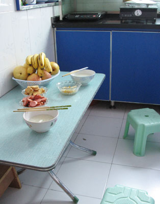 お粥（稀飯）や果物が並ぶ、中国三門峡の集合住宅台所での朝食